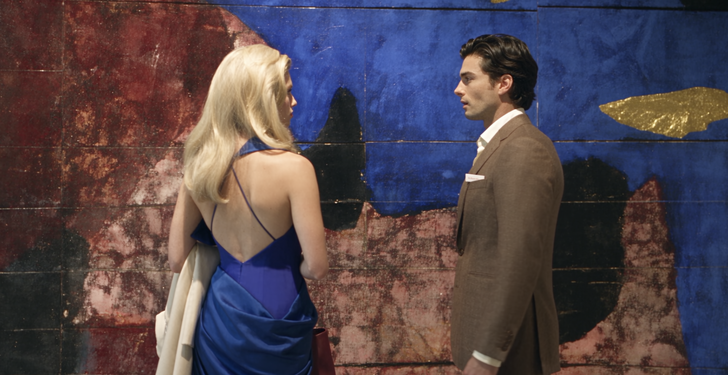Emma in a blue dress at the gallery opening